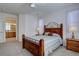 Comfortable bedroom with a ceiling fan, wooden furniture, neutral colors, natural light, and an ensuite bathroom at 10588 Parkington Ln # 39A, Highlands Ranch, CO 80126