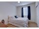 Bedroom with wood floors, bed, window, and closet at 10588 Parkington Ln # 39A, Highlands Ranch, CO 80126