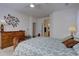 Comfortable bedroom with decorative wall art, wooden furniture, soft lighting, and an ensuite bathroom at 10588 Parkington Ln # 39A, Highlands Ranch, CO 80126