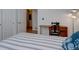 Bedroom featuring striped bedding, sewing machine, and a multi bulb floor lamp at 10588 Parkington Ln # 39A, Highlands Ranch, CO 80126
