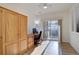 Bedroom with wood floors, wooden closet and desk, ceiling fan, and sliding glass door at 10588 Parkington Ln # 39A, Highlands Ranch, CO 80126