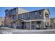 Inviting exterior view of a multi-story townhome featuring muted colors, a fenced front yard, and a charming covered porch at 10588 Parkington Ln # 39A, Highlands Ranch, CO 80126