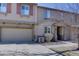 A townhome's front exterior features a two-car garage and inviting front porch at 10588 Parkington Ln # 39A, Highlands Ranch, CO 80126