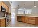 Spacious kitchen with stainless appliances, light cabinetry, and open layout to the dining and living spaces at 10588 Parkington Ln # 39A, Highlands Ranch, CO 80126
