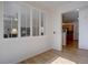 Light and bright living room featuring white shutters, wood floors, and a view of the kitchen at 10588 Parkington Ln # 39A, Highlands Ranch, CO 80126