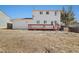 Spacious backyard featuring a two-story home, wooden deck, and fencing at 14552 E Tufts Ave, Aurora, CO 80015