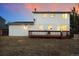 Backyard featuring a two-story home, wooden deck, and exterior lighting at 14552 E Tufts Ave, Aurora, CO 80015