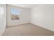 Well-lit bedroom with neutral carpeting and a single window providing natural light at 14552 E Tufts Ave, Aurora, CO 80015