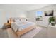 Serene bedroom with a comfortable bed, matching nightstands, and a large window offering scenic views at 14552 E Tufts Ave, Aurora, CO 80015