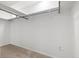 Bright walk-in closet with carpeted floors and metal hanging racks at 14552 E Tufts Ave, Aurora, CO 80015