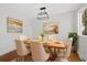 Elegant dining room with a modern chandelier, tasteful artwork, and seating for six guests at 14552 E Tufts Ave, Aurora, CO 80015