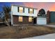Charming brick-front home with a two-car garage and well-maintained lawn at 14552 E Tufts Ave, Aurora, CO 80015