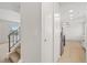 Hallway that connects to a kitchen with stainless steel appliances and staircase on the left at 14552 E Tufts Ave, Aurora, CO 80015