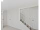 Hallway featuring a carpeted staircase and a closed door at 14552 E Tufts Ave, Aurora, CO 80015