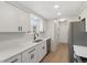 Bright white kitchen featuring shaker cabinets, quartz countertops, and stainless steel appliances at 14552 E Tufts Ave, Aurora, CO 80015