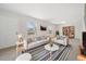 Bright living room with neutral tones, a striped rug, and an abundance of natural light at 14552 E Tufts Ave, Aurora, CO 80015