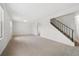 Bright and airy living room with neutral carpet and staircase at 14552 E Tufts Ave, Aurora, CO 80015