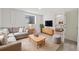 Cozy living room with a comfortable sofa, a wooden coffee table, and a view into the bedroom at 14552 E Tufts Ave, Aurora, CO 80015