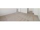 Carpeted living room with a doorway to a hallway and another room at 14552 E Tufts Ave, Aurora, CO 80015