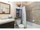 Bathroom featuring a toilet, sink, and shower with tiled walls, offering a clean and functional space at 1640 Aspen Meadows Cir, Federal Heights, CO 80260