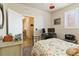 Bedroom featuring a workspace, white shutters, floral bedding, and ample closet space at 1640 Aspen Meadows Cir, Federal Heights, CO 80260