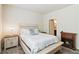 Bright bedroom with a decorative fireplace, neutral walls, and a white-painted wood bed frame at 1640 Aspen Meadows Cir, Federal Heights, CO 80260