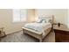 Neutral bedroom with a white-painted wood bed frame and window with white blinds at 1640 Aspen Meadows Cir, Federal Heights, CO 80260