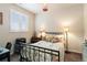 Bedroom with floral accents, a work space, and a window with white shutters at 1640 Aspen Meadows Cir, Federal Heights, CO 80260