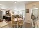 Open-concept dining area featuring a table with chairs, adjacent to a modern kitchen and cozy living room at 1640 Aspen Meadows Cir, Federal Heights, CO 80260