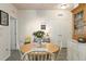 Bright dining room featuring a round wooden table with white chairs and a vintage hutch at 1640 Aspen Meadows Cir, Federal Heights, CO 80260