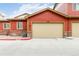 Attached two-car garage featuring a beige door, a brick facade, and easy access from the driveway at 1640 Aspen Meadows Cir, Federal Heights, CO 80260