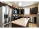 Modern kitchen with stainless steel appliances, granite countertops, and dark wood cabinets at 1640 Aspen Meadows Cir, Federal Heights, CO 80260