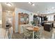 Bright kitchen and dining area with modern appliances, a dining table, and hardwood flooring at 1640 Aspen Meadows Cir, Federal Heights, CO 80260