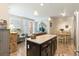 Open-concept living area with a kitchen island, living room, and dining area, creating an inviting atmosphere at 1640 Aspen Meadows Cir, Federal Heights, CO 80260
