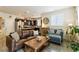 Open-concept living room with a comfortable sofa, accent chair, and adjacent kitchen with modern appliances at 1640 Aspen Meadows Cir, Federal Heights, CO 80260