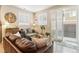 Comfortable living room with a large sofa, accent chair, and bright natural light from a sliding glass door at 1640 Aspen Meadows Cir, Federal Heights, CO 80260