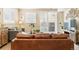 Cozy living room featuring a comfortable leather sofa, modern shutters, and stylish decor at 1640 Aspen Meadows Cir, Federal Heights, CO 80260