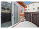 Cozy outdoor patio with a small seating area and a view of the surrounding neighborhood at 1640 Aspen Meadows Cir, Federal Heights, CO 80260