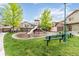 Community playground area with a slide, swings, and picnic tables for residents to enjoy at 1640 Aspen Meadows Cir, Federal Heights, CO 80260