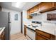 Simple kitchen with wood cabinets and an electric stovetop at 8335 Fairmount Dr # 7-204, Denver, CO 80247