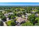 Panoramic aerial view highlighting the home within a community of well-maintained properties, mature trees, and lush landscapes at 7355 Nile St, Arvada, CO 80007