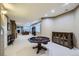 Spacious finished basement with a recreation area, office space, and neutral carpeting at 7355 Nile St, Arvada, CO 80007
