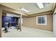 A home gym in the basement with weight training equipment and bright lighting at 7355 Nile St, Arvada, CO 80007