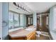 Well-lit bathroom with tiled countertop, framed mirror, and glass shower enclosure at 7355 Nile St, Arvada, CO 80007