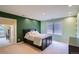 Spacious bedroom featuring neutral carpet, light walls and modern finishes, a large window, and access to another room at 7355 Nile St, Arvada, CO 80007