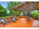 Outdoor deck with a wood pergola, dining set, and comfortable seating area at 7355 Nile St, Arvada, CO 80007