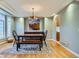Dining area featuring hardwood floors, modern chandelier, and stylish decor at 7355 Nile St, Arvada, CO 80007