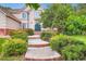 Beautiful two-story home featuring a manicured lawn and garden, brick accents, and a private entrance at 7355 Nile St, Arvada, CO 80007