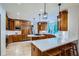Modern kitchen featuring custom cabinets, white countertops, a large island, and stainless steel appliances at 7355 Nile St, Arvada, CO 80007