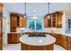 Charming kitchen with wood cabinets, a gas cooktop island and natural light at 7355 Nile St, Arvada, CO 80007